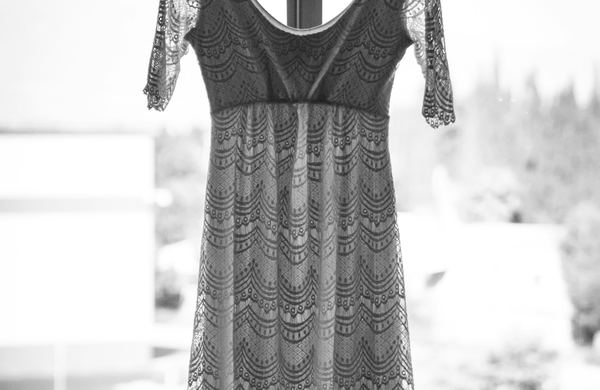 Vestido longo de renda pendurado, em foto preto e branco